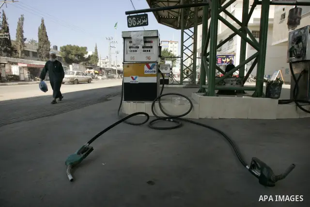 Palestinian man walks past in a petrol station in Rafah, southern Gaza Strip on February, 06, 2011. Fuel stations in the Gaza Strip free of fuel, due to suspension of the fuel line through border tunnels between Egypt an...