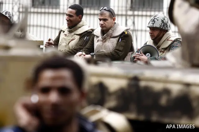 Egyptian soldiers stand guards at Tahrir Square in Cairo Feb. 6, 2011. Demonstrators camped out in Cairo's Tahrir Square, which has become an epicentre for protest, vowed to intensify their battle to oust Egypt's Preside...