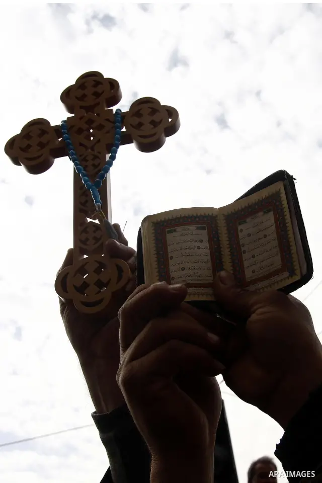 Opposition supporters hold Holy Quran and a cross in Tahrir Square in Cairo February 6, 2011. Demonstrators camped out in Cairo's Tahrir Square, which has become an epicentre for protest, vowed to intensify their battle...