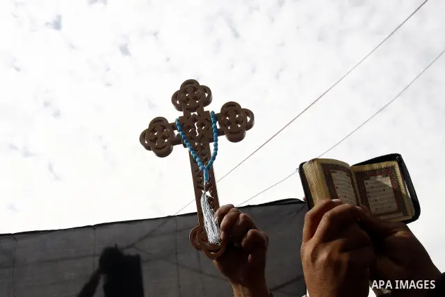 Opposition supporters hold Holy Quran and a cross in Tahrir Square in Cairo February 6, 2011. Demonstrators camped out in Cairo's Tahrir Square, which has become an epicentre for protest, vowed to intensify their battle...