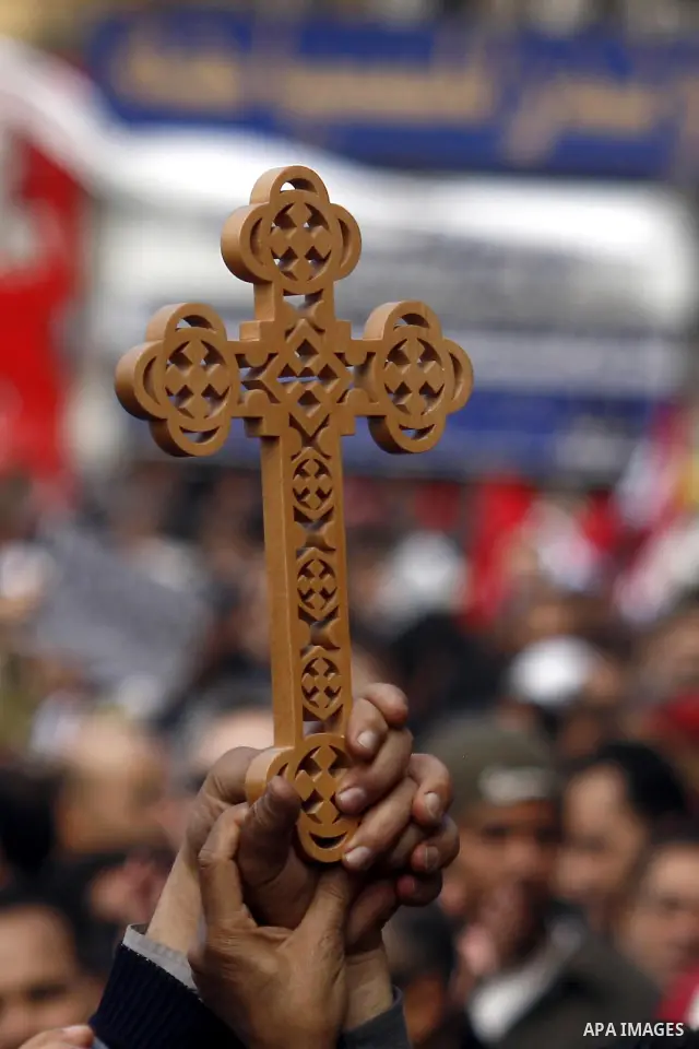 An opposition supporter holds a cross in Tahrir Square in Cairo February 6, 2011. Demonstrators camped out in Cairo's Tahrir Square, which has become an epicentre for protest, vowed to intensify their battle to oust Egyp...