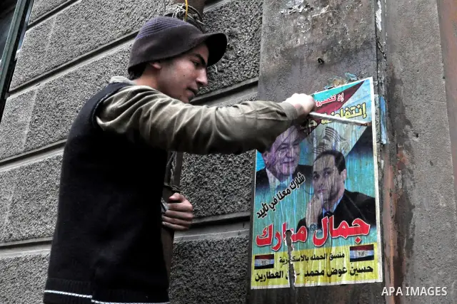 Egyptian protesters damage posters depicting President Hosni Mubarak during a protest called 'Sunday of the martyrs' in Alexandria, Egypt, 06 February 2011. Anti-government protests entered its 13th straight day in Egypt...