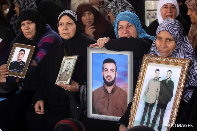 Palestinian women hold pictures of jailed relatives during a protest calling for the release of Palestinian prisoners from Israeli jails at the Red Cross office in Gaza City on Feb. 7,2011. Photo by Mohammed Asad