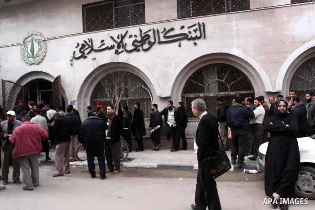 Palestinian employees queue in front of the National Islamic bank in Gaza city on Feb. 7,2011. Photo by Mohammed Asad