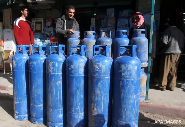 A Palestinian man displays gas canisters which were smuggled through the tunnels underground border between Egypt and Rafah at his shop in Gaza city on Feb. 7,2011 as Gaza Strip suffer from the shortage of natural gas. P...
