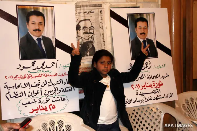 The daughter of the Egyptian journalist, Ahmed Mohammed Mahmoud takes part in a symbolic funeral ceremony for her father in Tahrir Square, Cairo, Egypt, Monday, Feb. 7, 2011. The reporter who was shot during clashes a we...