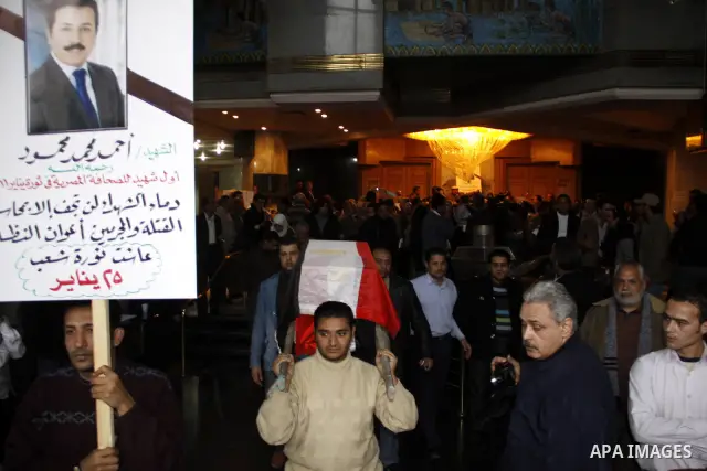 People carry a symbolic coffin of Egyptian journalist Ahmed Mohammed Mahmoud, in symbolic funeral ceremony in Tahrir Square, Cairo, Egypt, Monday, Feb. 7, 2011. The reporter who was shot during clashes a week ago died of...