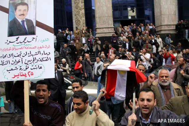 People carry a symbolic coffin of Egyptian journalist Ahmed Mohammed Mahmoud, in symbolic funeral ceremony in Tahrir Square, Cairo, Egypt, Monday, Feb. 7, 2011. The reporter who was shot during clashes a week ago died of...