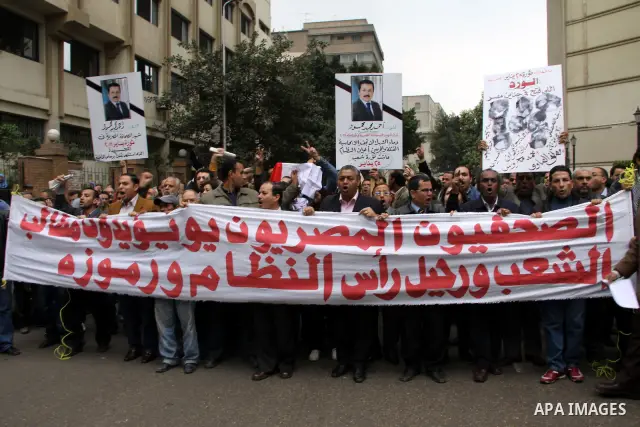 People carry a symbolic coffin of Egyptian journalist Ahmed Mohammed Mahmoud, in symbolic funeral ceremony in Tahrir Square, Cairo, Egypt, Monday, Feb. 7, 2011. The reporter who was shot during clashes a week ago died of...