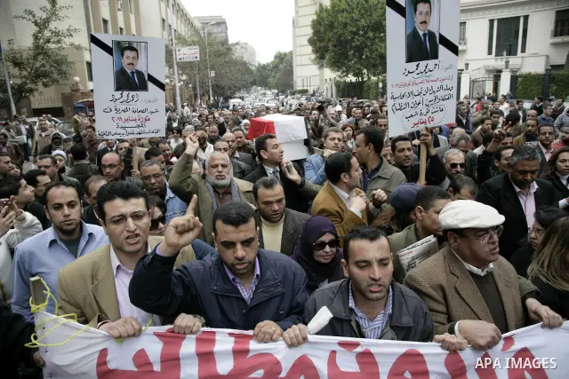 People carry a symbolic coffin of Egyptian journalist Ahmed Mohammed Mahmoud, in symbolic funeral ceremony in Tahrir Square, Cairo, Egypt, Monday, Feb. 7, 2011. The reporter who was shot during clashes a week ago died of...