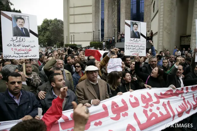 People carry a symbolic coffin of Egyptian journalist Ahmed Mohammed Mahmoud, in symbolic funeral ceremony in Tahrir Square, Cairo, Egypt, Monday, Feb. 7, 2011. The reporter who was shot during clashes a week ago died of...