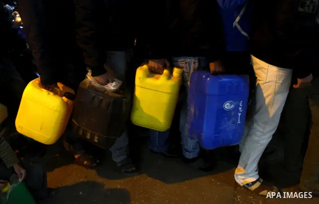 Palestinians wait to fill petrol in containers at a petrol station in Gaza city on Feb. 7, 2011. Gaza Strip residents flocked to petrol stations after clashes in neighbouring Egypt hampered smugglers ferrying fuel suppli...