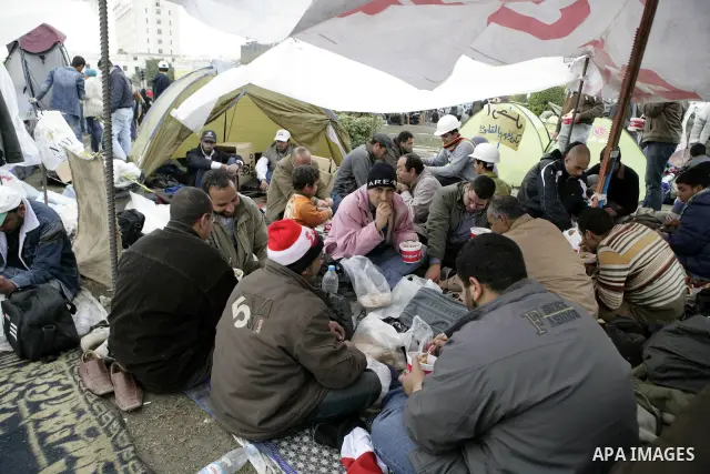Egyptian anti-government protesters eat in Tahrir Square in Cairo, Egypt, Monday, Feb. 7, 2011. The protests, which saw tens of thousands of people massing daily in downtown Cairo for demonstrations that at times turned...