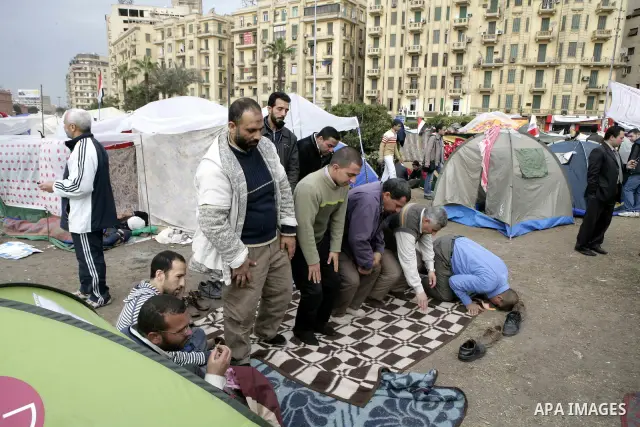 Egyptian anti-government protesters pray in Tahrir Square in Cairo, Egypt, Monday, Feb. 7, 2011. The protests, which saw tens of thousands of people massing daily in downtown Cairo for demonstrations that at times turned...