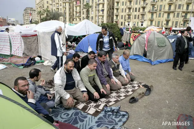 Egyptian anti-government protesters pray in Tahrir Square in Cairo, Egypt, Monday, Feb. 7, 2011. The protests, which saw tens of thousands of people massing daily in downtown Cairo for demonstrations that at times turned...
