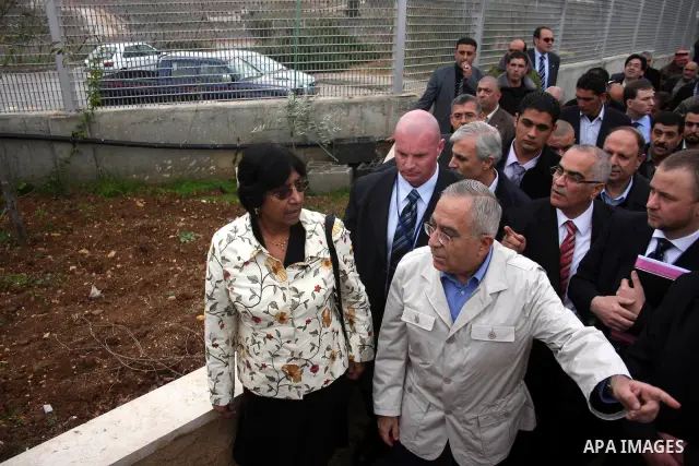 U.N. High Commissioner for Human Rights Navi Pillay and Palestinian prime minister Salam Fayyad visit the Sabri Gareeb Palestinian family home which is situated in the center of the settlement just south of Ramallah in t...