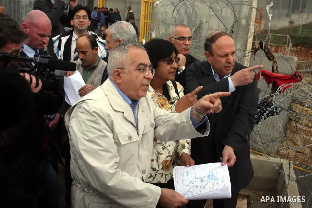 U.N. High Commissioner for Human Rights Navi Pillay and Palestinian prime minister Salam Fayyad visit the Sabri Gareeb Palestinian family home which is situated in the center of the settlement just south of Ramallah in t...