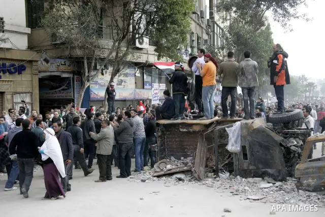 Anti-government protesters take part in demonstrations in Tahrir Square in downtown Cairo, Egypt, Tuesday, Feb. 8, 2011. Protesters appear to have settled in for a long standoff, turning Tahrir Square into a makeshift vi...