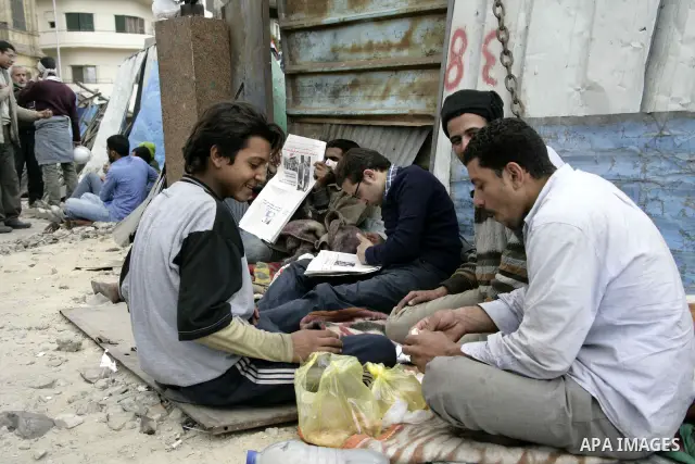Anti-government protesters take part in demonstrations in Tahrir Square in downtown Cairo, Egypt, Tuesday, Feb. 8, 2011. Protesters appear to have settled in for a long standoff, turning Tahrir Square into a makeshift vi...
