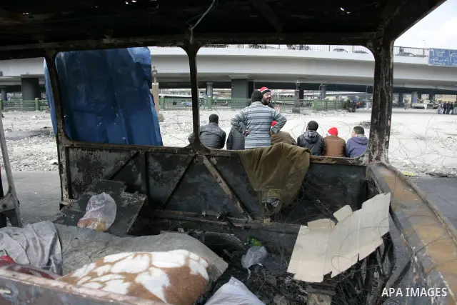 Anti-government protesters take part in demonstrations in Tahrir Square in downtown Cairo, Egypt, Tuesday, Feb. 8, 2011. Protesters appear to have settled in for a long standoff, turning Tahrir Square into a makeshift vi...
