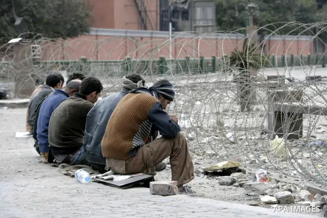 Anti-government protesters take part in demonstrations in Tahrir Square in downtown Cairo, Egypt, Tuesday, Feb. 8, 2011. Protesters appear to have settled in for a long standoff, turning Tahrir Square into a makeshift vi...