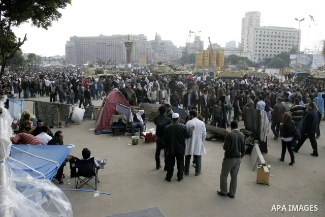 Anti-government protesters take part in demonstrations in Tahrir Square in downtown Cairo, Egypt, Tuesday, Feb. 8, 2011. Protesters appear to have settled in for a long standoff, turning Tahrir Square into a makeshift vi...