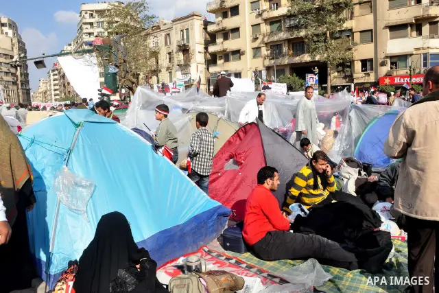 Anti-government protesters take part in demonstrations in Tahrir Square in downtown Cairo, Egypt, Tuesday, Feb. 8, 2011. Protesters appear to have settled in for a long standoff, turning Tahrir Square into a makeshift vi...