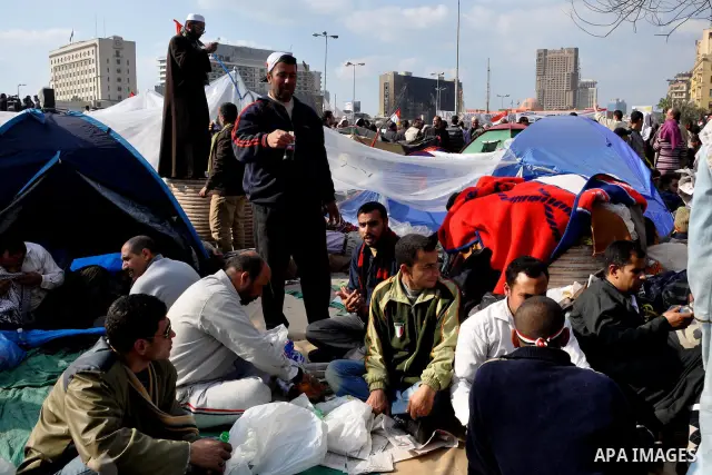 Anti-government protesters take part in demonstrations in Tahrir Square in downtown Cairo, Egypt, Tuesday, Feb. 8, 2011. Protesters appear to have settled in for a long standoff, turning Tahrir Square into a makeshift vi...