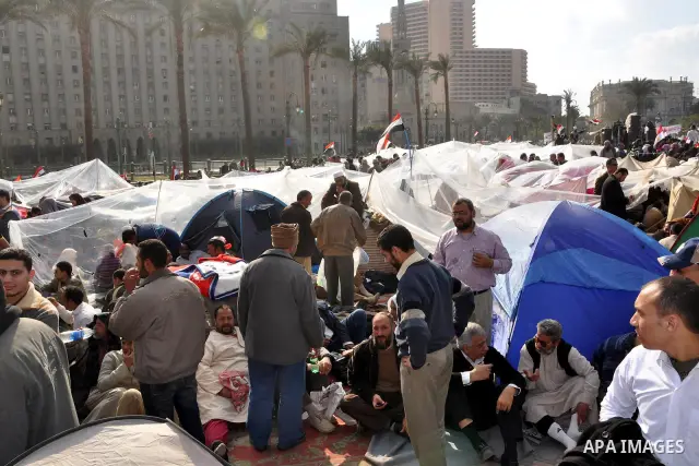 Anti-government protesters take part in demonstrations in Tahrir Square in downtown Cairo, Egypt, Tuesday, Feb. 8, 2011. Protesters appear to have settled in for a long standoff, turning Tahrir Square into a makeshift vi...