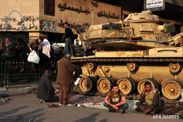 Anti-government protesters take part in demonstrations in Tahrir Square in downtown Cairo, Egypt, Tuesday, Feb. 8, 2011. Protesters appear to have settled in for a long standoff, turning Tahrir Square into a makeshift vi...
