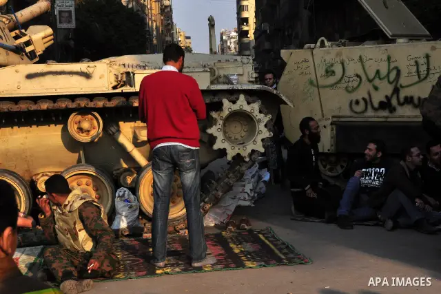Anti-government protesters take part in demonstrations in Tahrir Square in downtown Cairo, Egypt, Tuesday, Feb. 8, 2011. Protesters appear to have settled in for a long standoff, turning Tahrir Square into a makeshift vi...