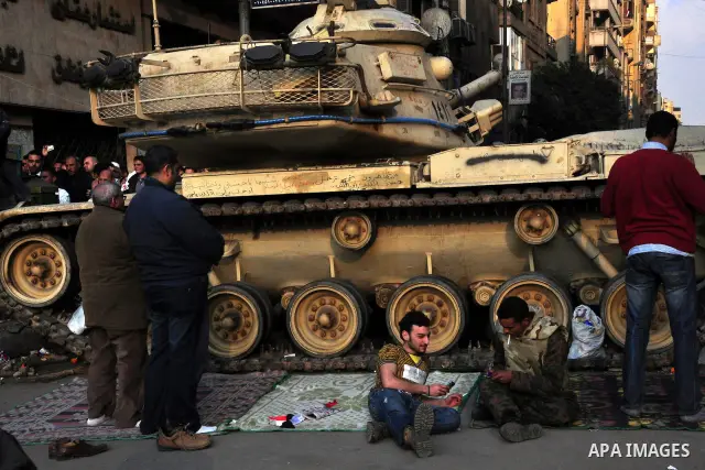 Anti-government protesters take part in demonstrations in Tahrir Square in downtown Cairo, Egypt, Tuesday, Feb. 8, 2011. Protesters appear to have settled in for a long standoff, turning Tahrir Square into a makeshift vi...