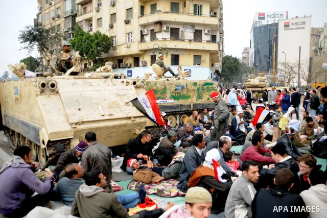 Anti-government protesters take part in demonstrations in Tahrir Square in downtown Cairo, Egypt, Tuesday, Feb. 8, 2011. Protesters appear to have settled in for a long standoff, turning Tahrir Square into a makeshift vi...