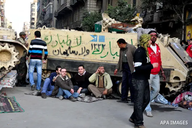 Anti-government protesters take part in demonstrations in Tahrir Square in downtown Cairo, Egypt, Tuesday, Feb. 8, 2011. Protesters appear to have settled in for a long standoff, turning Tahrir Square into a makeshift vi...