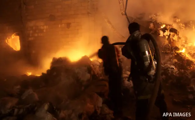 Palestinian firefighters try to extinguish a fire at a burning medicine warehouse in Gaza City, Wednesday, Feb. 9, 2011. Early Wednesday, Israeli aircraft carried out air strikes against four targets including Hamas and...