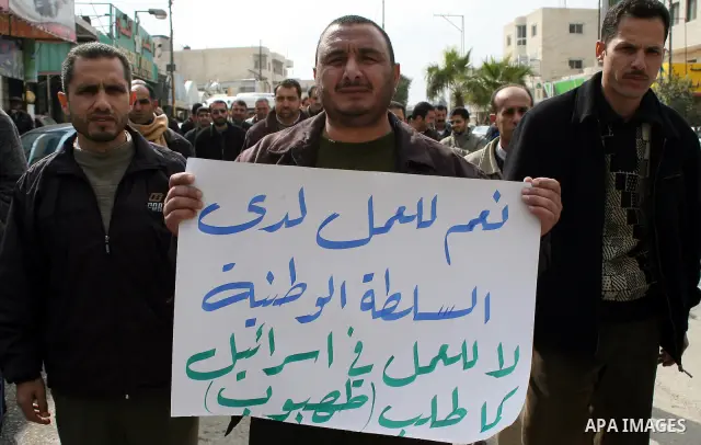 Palestinian teachers take part in a demonstration outside the office of the Directorate of Education in the West Bank town of Halhoul, north of Hebron on Feb. 9,2011. Photo by Najeh Hashlamoun