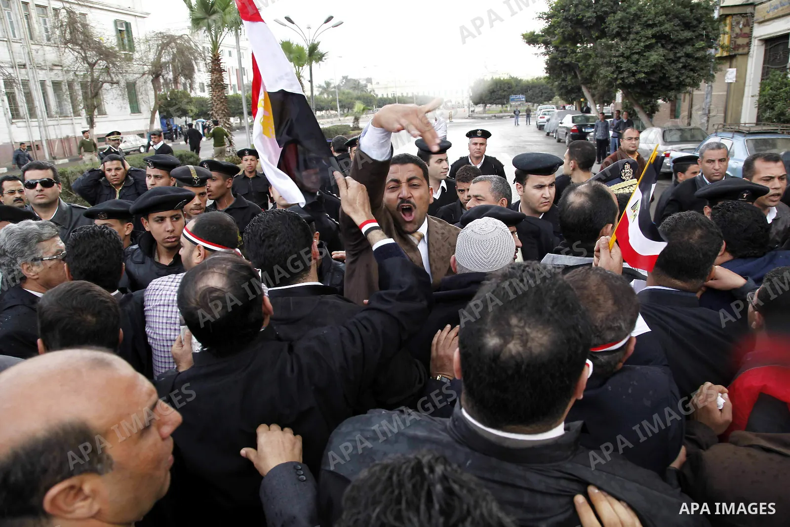 Egyptian protesters demonstrate at the gate of the presidential palace in Cairo, Egypt, Thursday, Feb. 10, 2011. Egypt's foreign minister warns of a military coup if protesters continue mass demonstrations and don't foll...