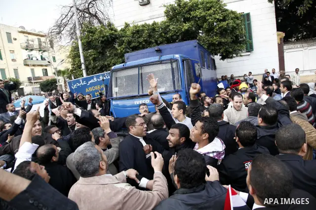 Egyptian protesters demonstrate at the gate of the presidential palace in Cairo, Egypt, Thursday, Feb. 10, 2011. Egypt's foreign minister warns of a military coup if protesters continue mass demonstrations and don't foll...