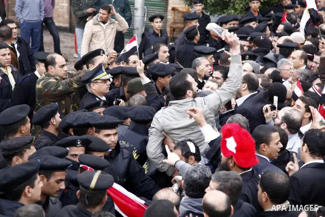 Egyptian riot police clashes with Egyptian protesters demonstrate at the gate of the presidential palace in Cairo, Egypt, Thursday, Feb. 10, 2011. Egypt's foreign minister warns of a military coup if protesters continue...