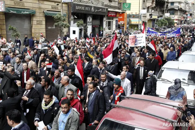 Egyptian protesters demonstrate at the gate of the presidential palace in Cairo, Egypt, Thursday, Feb. 10, 2011. Egypt's foreign minister warns of a military coup if protesters continue mass demonstrations and don't foll...