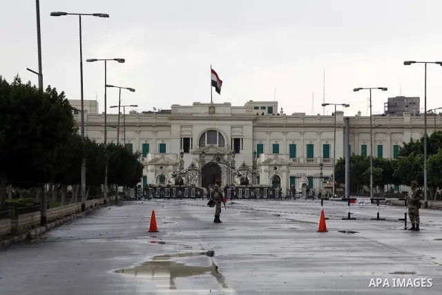 Egyptian soldiers stand guards as protesters demonstrate at the gate of the presidential palace in Cairo, Egypt, Thursday, Feb. 10, 2011. Egypt's foreign minister warns of a military coup if protesters continue mass demo...