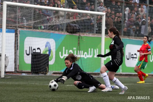 Palestinian Deyar players and Siryah Ramallah play in the opening soccer match of the Palestinian women's soccer league in the West Bank town of Aram, near Ramallah, Thursday, Feb. 10, 2011. Photo by Issam Rimawi
