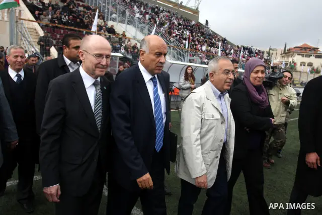 Palestinian prime minister Salam Fayyad participates the opening soccer match of the Palestinian women's soccer league between Siryah Ramallah and Deyar in the West Bank town of Aram, near Ramallah, Thursday, Feb. 10, 20...