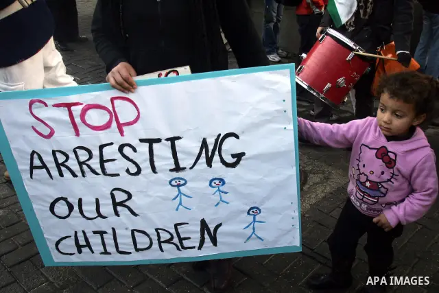 Palestinians, Israelis and foreign activists hold signs during a protest to show solidarity with Palestinian families against a Jewish settlement in the Sheikh Jarrah neighbourhood in East Jerusalem on Feb. 11, 2011. Pho...
