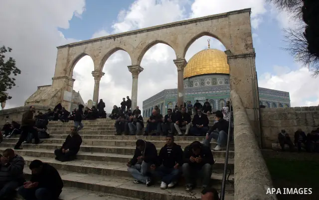 Palestinians attend Friday prayers in front of the Dome of the Rock at the Al-Aqsa Mosque compound in Jerusalem's Old City on February 11, 2011. Photo by Mahfouz Abu Turk