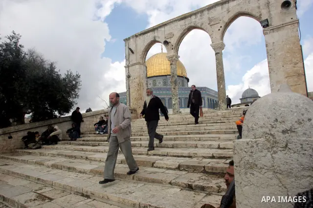 Palestinians attend Friday prayers in front of the Dome of the Rock at the Al-Aqsa Mosque compound in Jerusalem's Old City on February 11, 2011. Photo by Mahfouz Abu Turk