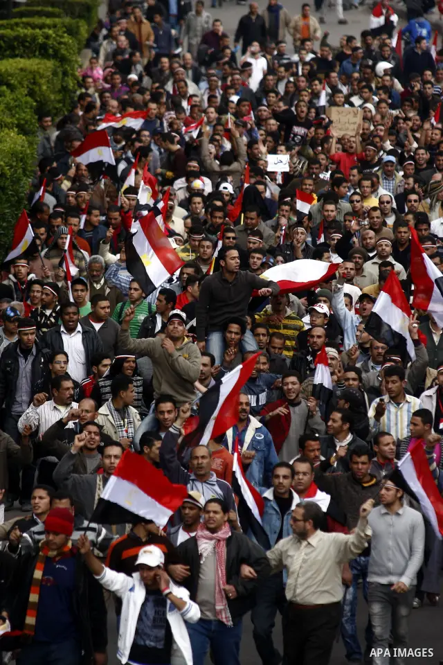 Egyptian anti-government protesters shout in front of Ettehadyya Presidential palace in Cairo, Egypt, Friday, Feb. 11, 2011. Egypt's military seemed to throw its weight Friday behind President Hosni Mubarak's plan to sta...