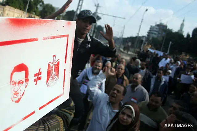 Egyptian anti-government protesters shout in front of Ettehadyya Presidential palace in Cairo, Egypt, Friday, Feb. 11, 2011. Egypt's military seemed to throw its weight Friday behind President Hosni Mubarak's plan to sta...