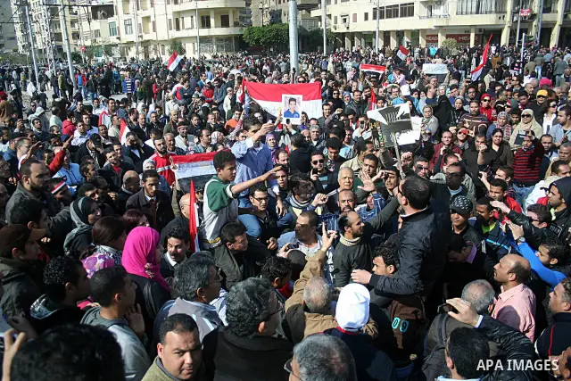 Egyptian anti-government protesters shout in front of Ettehadyya Presidential palace in Cairo, Egypt, Friday, Feb. 11, 2011. Egypt's military seemed to throw its weight Friday behind President Hosni Mubarak's plan to sta...