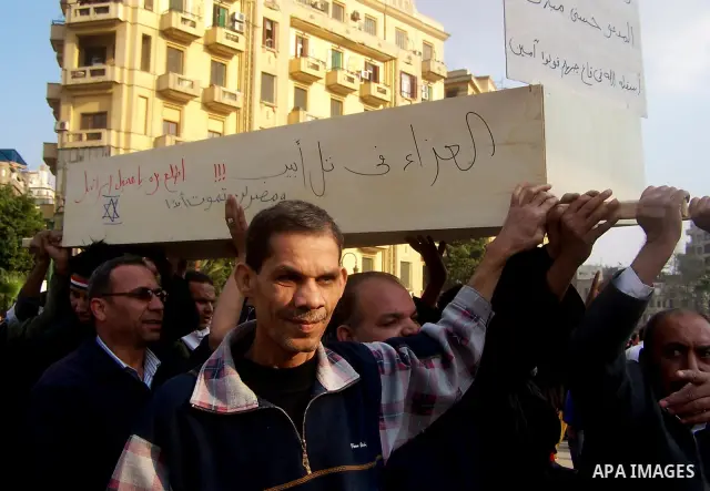 Anti-government protesters gather in front the state television building in Cairo, Egypt, Friday, Feb. 11, 2011. Mubarak has refused to step down or leave the country, and instead handed his administrative powers to his...